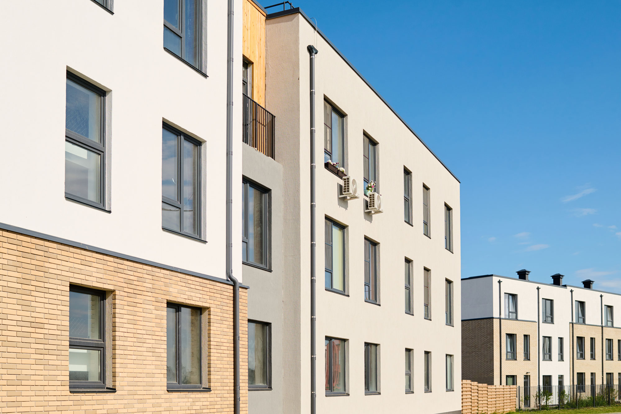 perspective of apartment buildings with rows of glass windows